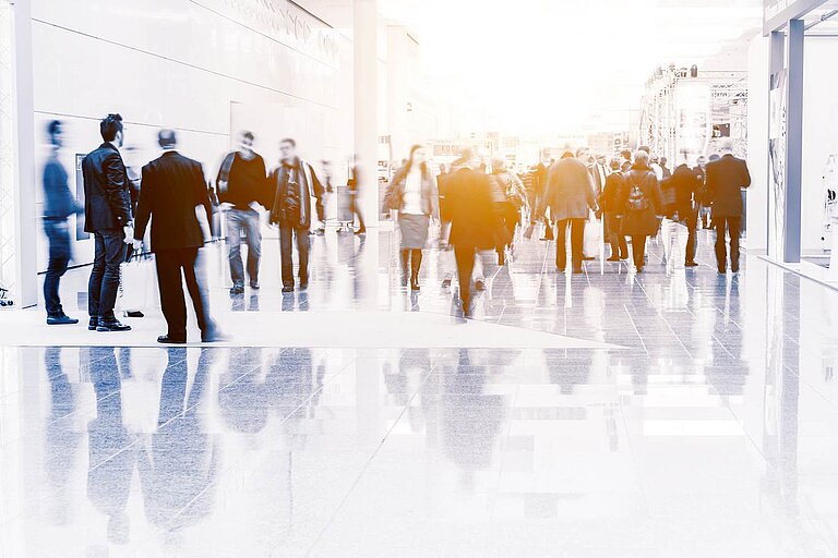 Exhibition hall with stands and visitors
